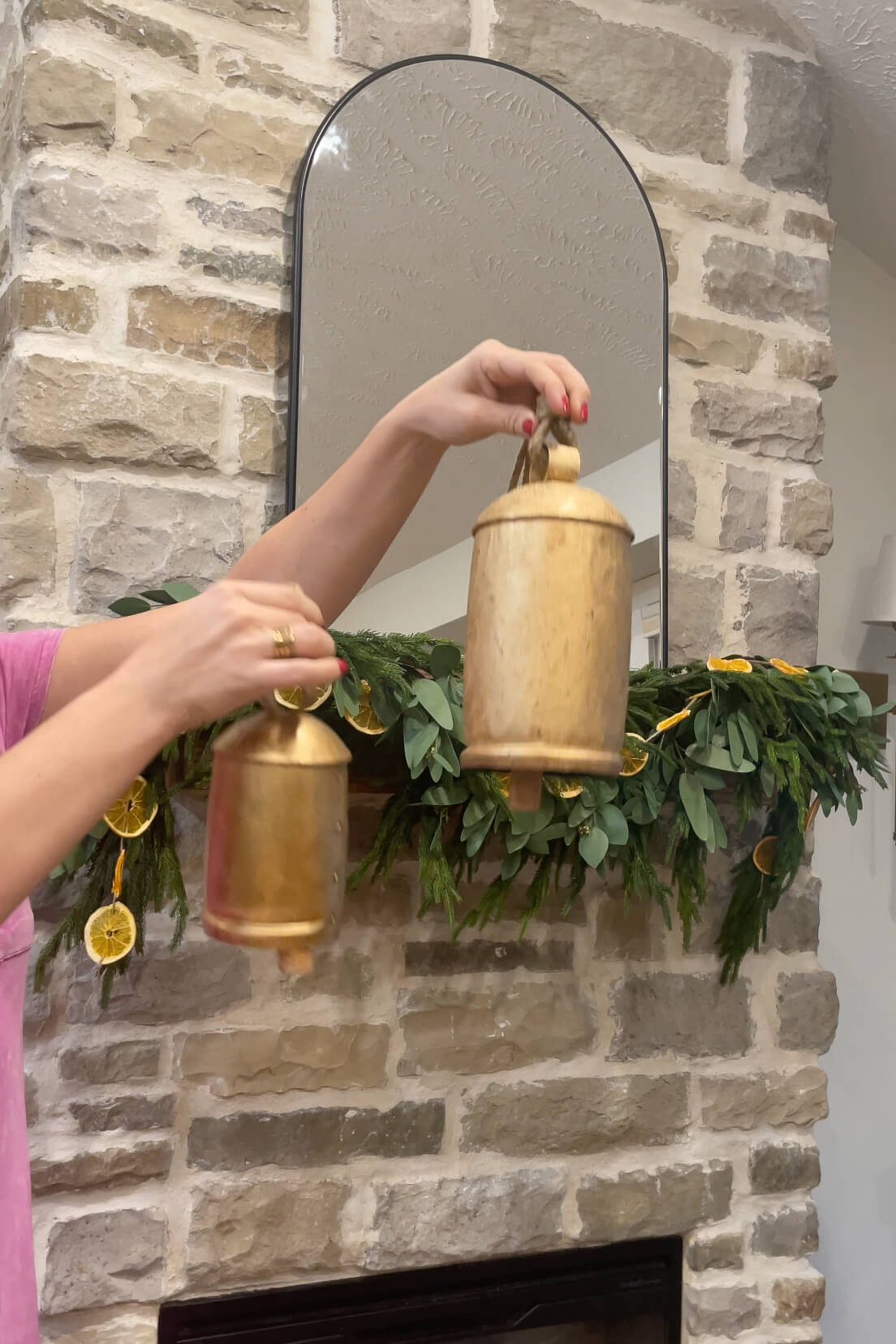 Rustic brass bells for fireplace Christmas decor.